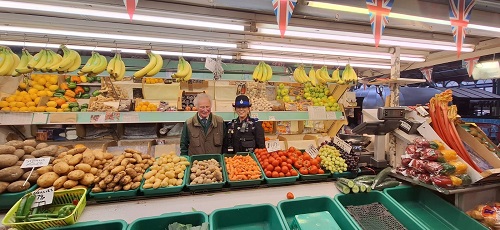 PCSO Lucy Brown with greengrocer Robin Blair at his stall