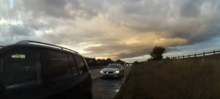 Bodycam screenshot showing a police car