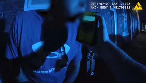 Still of a person being breathalysed 
