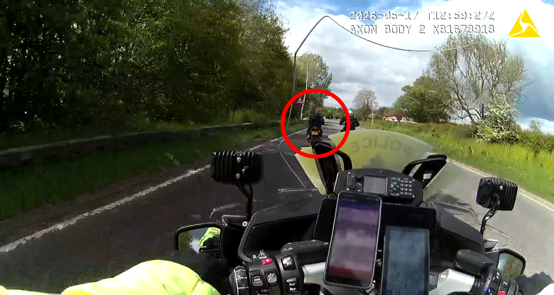 A screenshot of the body worn video showing the motorcyle officer pursuing the motorbike which is circled in a red ring