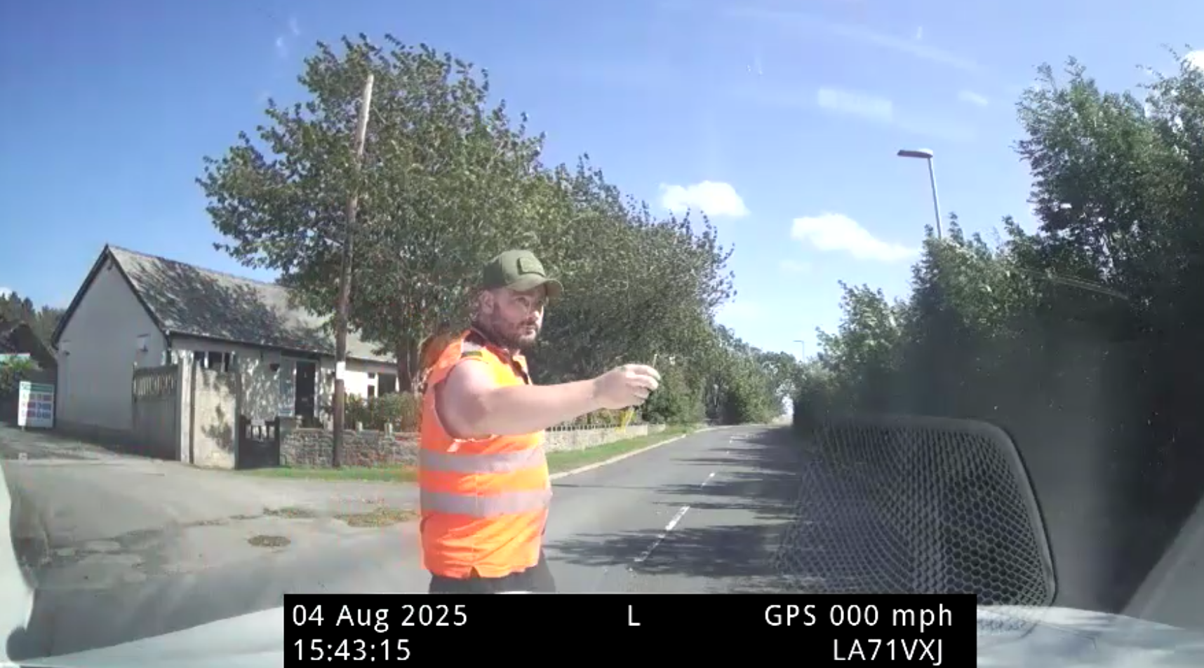 Police car dashcam showing Robert Holliday walking round the front of the car with keys in hand.