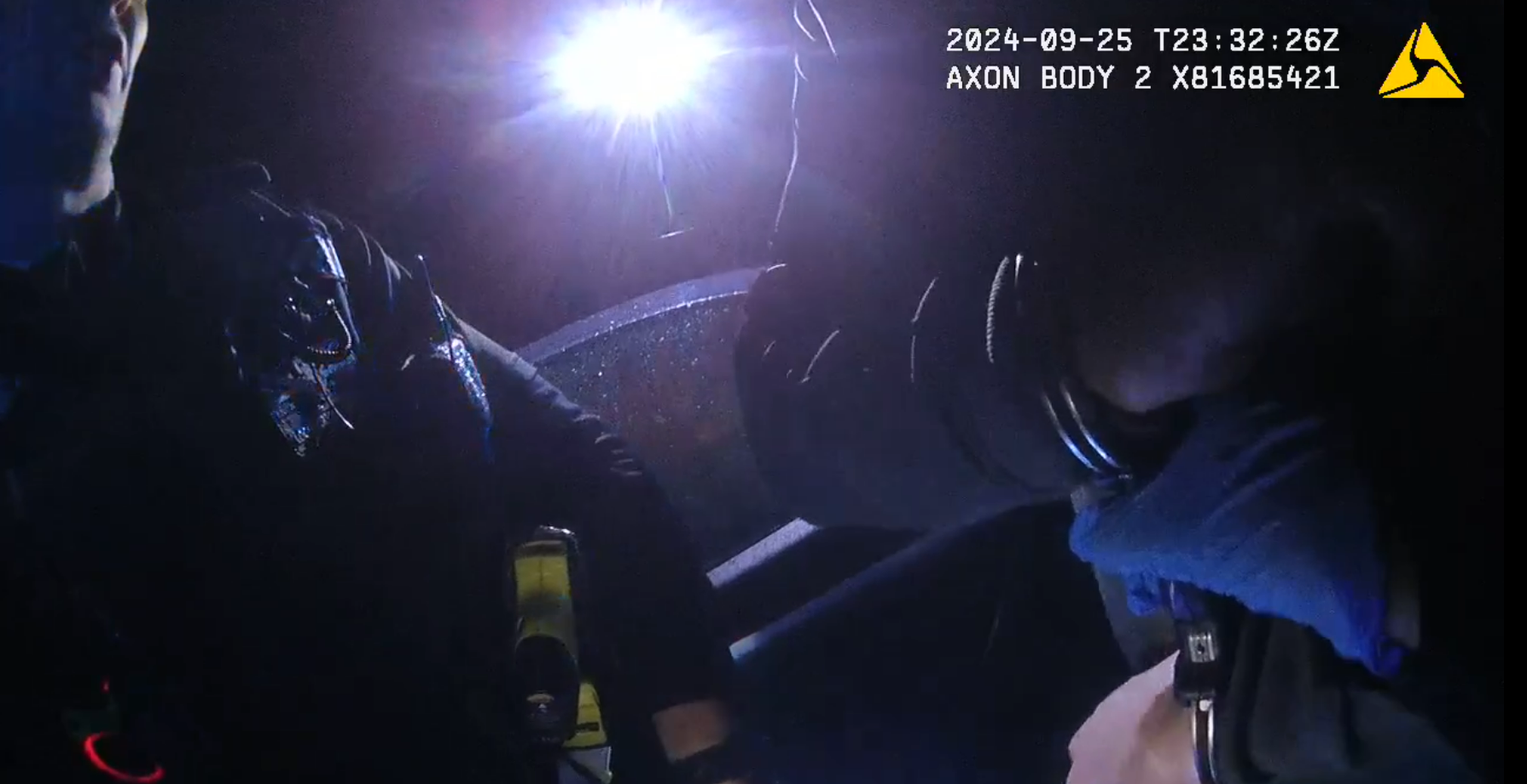 Police officers holds suspect in cuffs