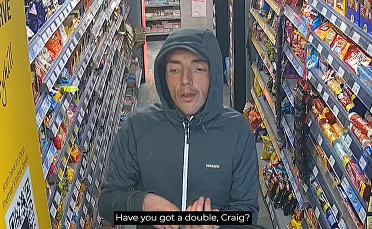 A CCTV image showing Criag Johson walking down a store aisle