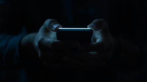 Man using phone in dark.jpg