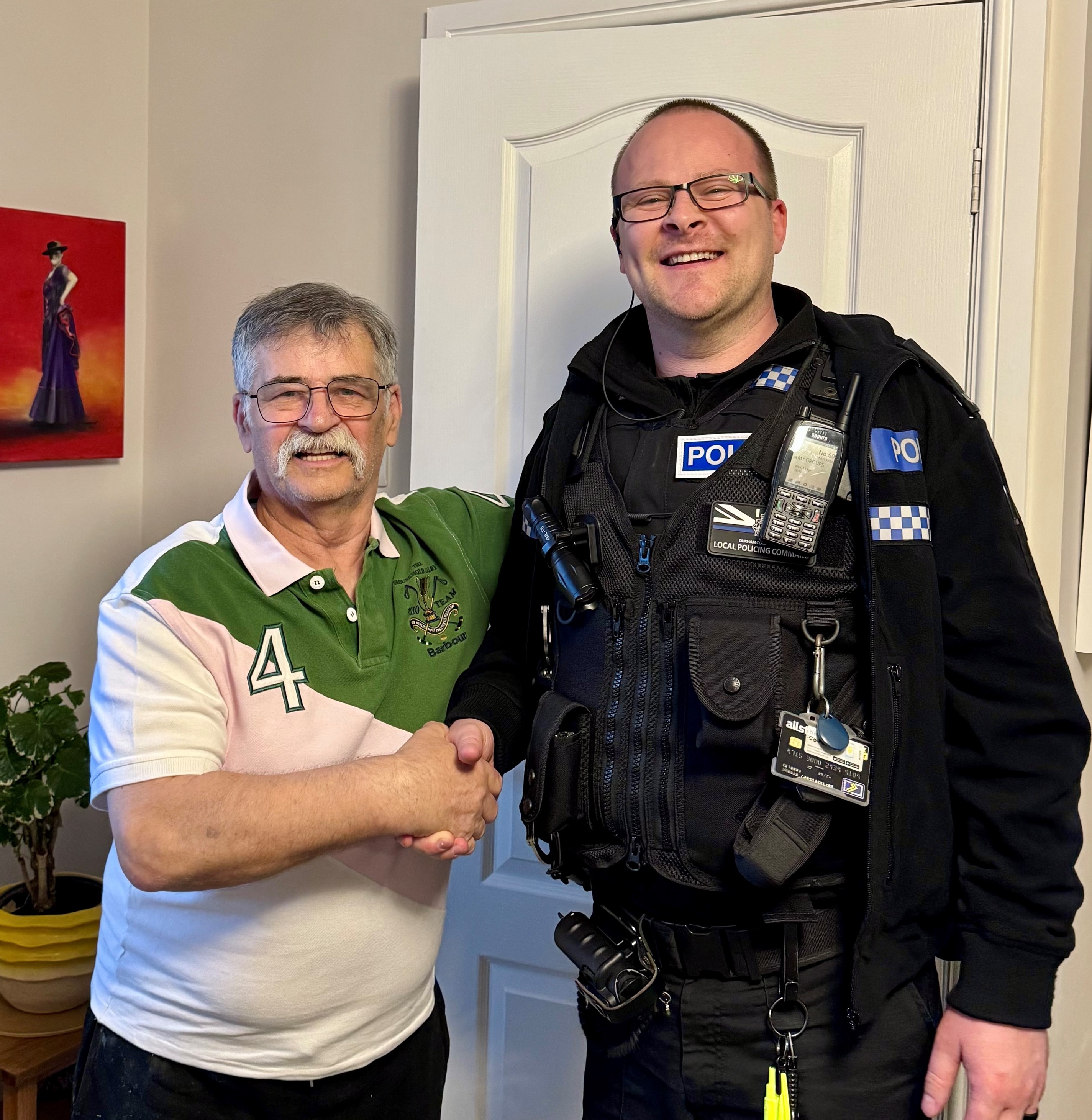 Mr Thomson shaking hands with PC Hubbard