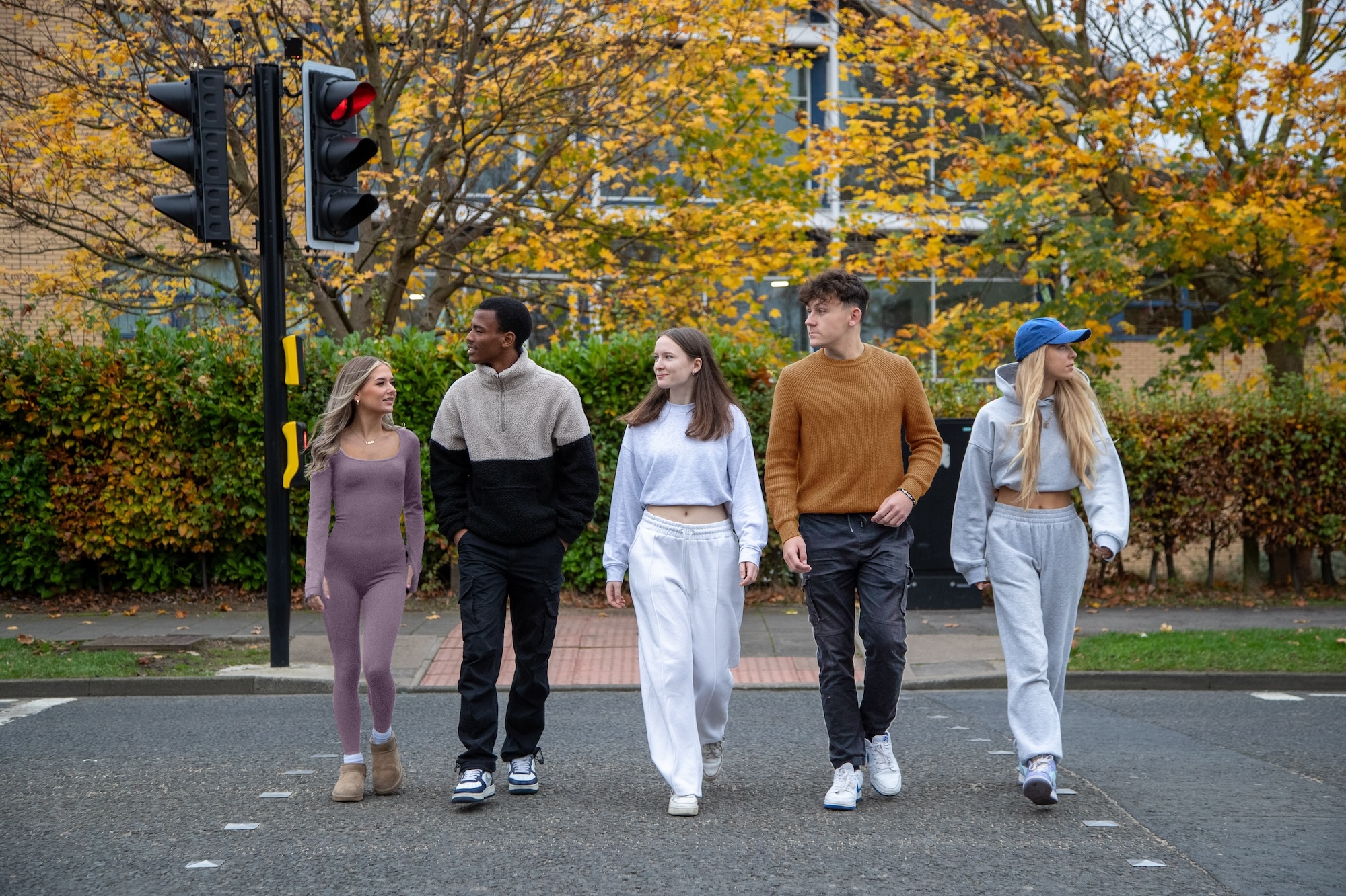 Young people walking across a pedestrian crossing