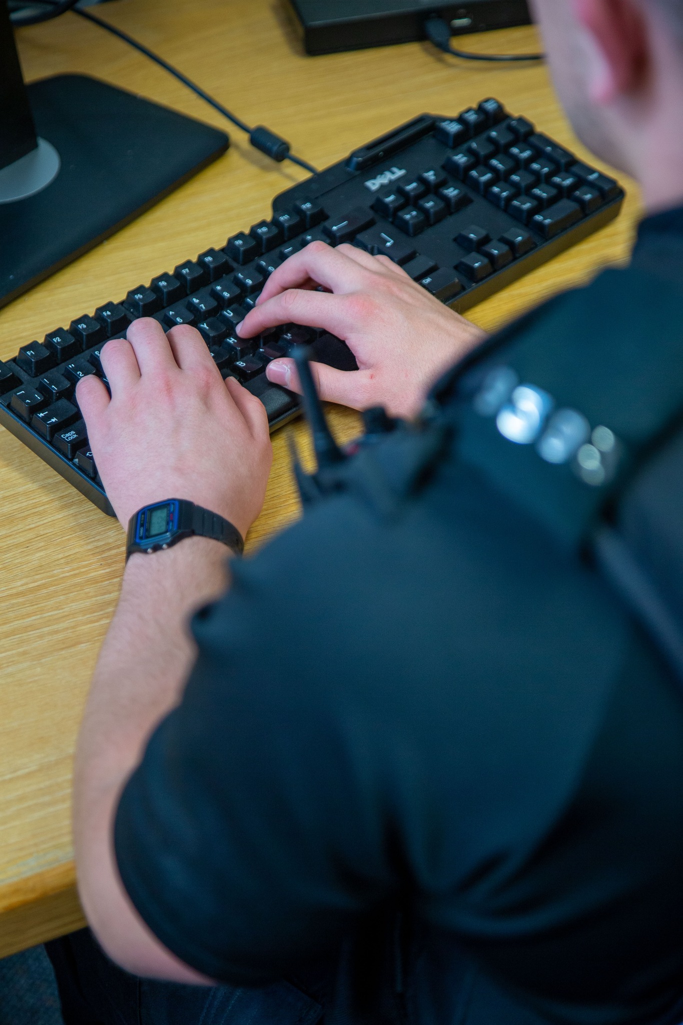 Police officer typing on keyboard